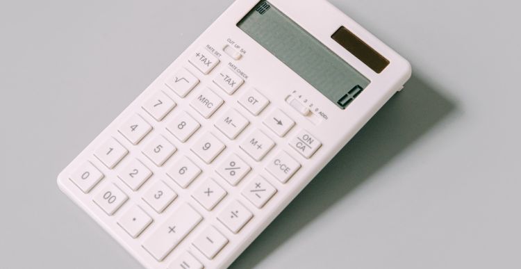 Image of a white calculator against a black background