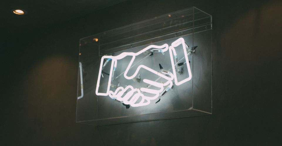 Neon sign of a handshake